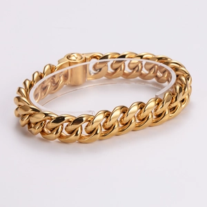 Men's bold gold-plated Cuban link bracelet with round push-lock clasp on display stand