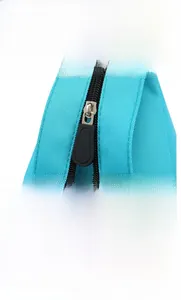 Detail of high-quality smooth black zipper and nylon fabric on blue crossbody bag