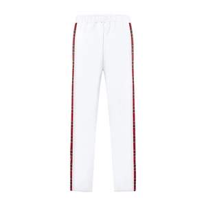 Detail of white casual pants featuring classic red plaid side stripe decorations