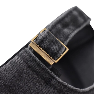 Close-up of vintage bronze buckle and adjustable fabric strap on washed cotton baseball cap
