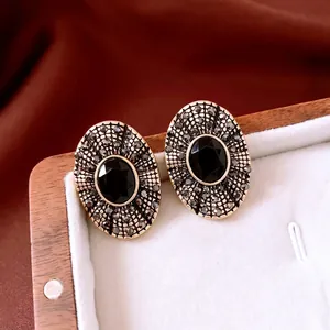 Vintage oval black gemstone earrings in antique gold setting with small black crystals