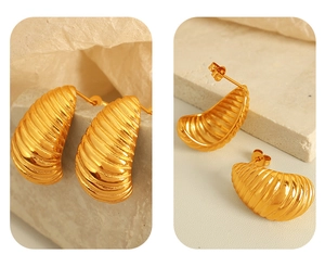Detail of 18K gold plated stainless steel earrings with irregular spiral texture design