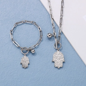 Detailed view of silver Hamsa hand charms and OT toggle clasp on linked chain set
