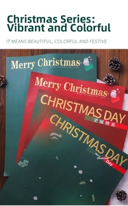 Detail of red and green Christmas wrapping paper with gold lettering and pine cones