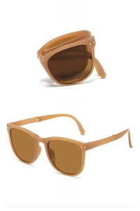 Foldable square sunglasses in tea-colored frames showing folding hinge detail