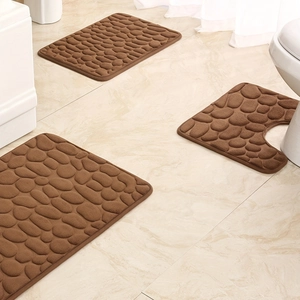 Three-piece brown bathroom rug set with embossed pebble texture on marble flooring