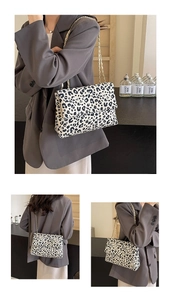 Three-angle views of a stylish leopard print handbag with gold chain strap detail