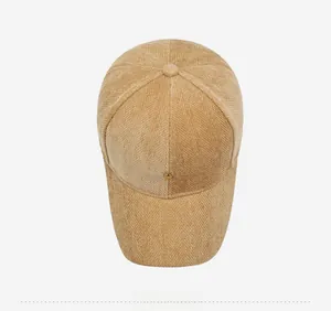 Top down view of khaki corduroy baseball cap with crown metal emblem and texture