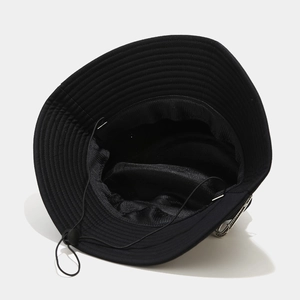 Detail of black bucket hat featuring breathable mesh lining and adjustable windproof drawstring