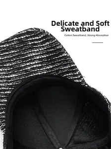 Detail view of cotton sweatband on a black and white tweed baseball cap