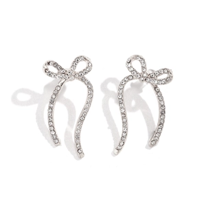 Detail of silver bow earrings with pavé set crystals and fine ribbon knot texture