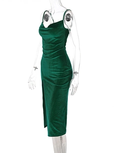 Detail of dark green velvet cami dress featuring a cowl neck and elegant side slit