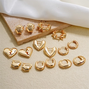 Set of minimalist geometric gold hollow earrings in shell and heart styles