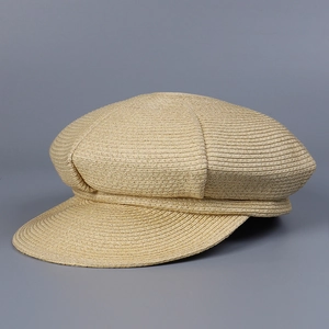 Detailed view of the uniform texture on this woven straw newsboy cap with a short brim