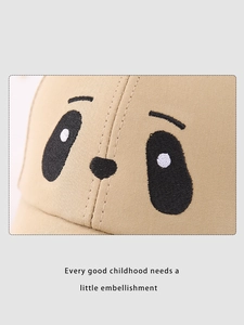 Detailed close-up of cartoon panda embroidery on a khaki cotton children baseball cap