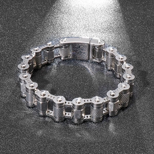 Detailed close-up of industrial silver stainless steel skull bike chain bracelet for men