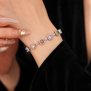 Close-up of vintage multi-color zircon bracelet with square cut stones on black velvet