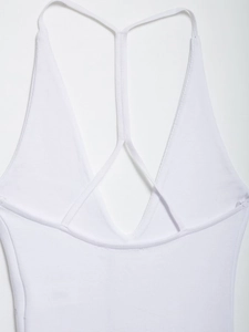 Detail of white ribbed bodysuit showing cross-back spaghetti straps and deep V-neckline