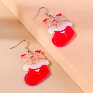 Detail shot of acrylic Christmas stocking earrings featuring cute deer and metal hooks