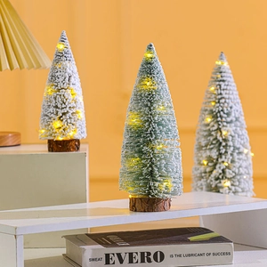 Mini flocked Christmas trees with warm LED lights and wooden bases for desk decoration