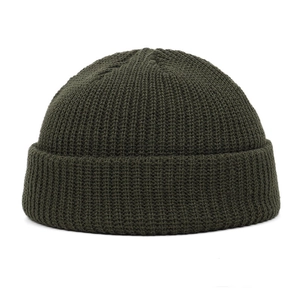 Close-up of olive green knit beanie showing detailed texture and high-quality stitching