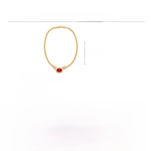 Detailed view of vintage gold chain necklace with red oval gemstone and rhinestones