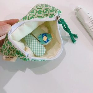 Floral cotton mini storage pouch with zipper closure and simple wish woven label