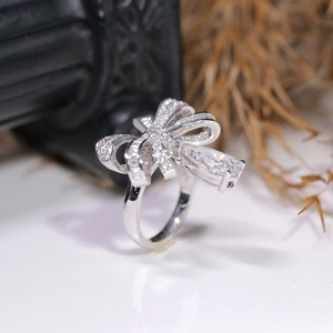 Macro shot of bow-shaped ring featuring pavé stones and a pear-cut droplet center diamond