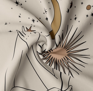 Close-up of soft Morandi tapestry fabric with minimalist moon and star prints