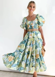 Detail of layered tiered skirt and brown square buckle belt on polka dot dress