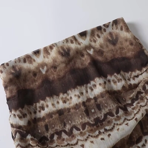 Detail of bohemian fabric with ethnic prints and gold metallic thread embroidery