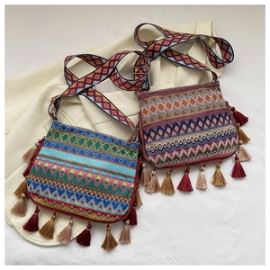 Close-up of Bohemian crossbody bags with intricate ethnic embroidery and fringe details