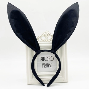 Detail of black satin rabbit ears headband with poseable wire inside on a vintage frame