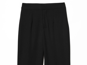 Detail of elegant black flared trousers featuring waist design and high-quality twill fabric