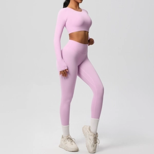 Side view of pink seamless long sleeve crop top and high waist yoga leggings set