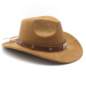 Detail of camel suede cowboy hat featuring brown leather band and antique metal badge