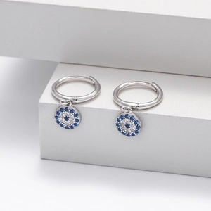 Macro view of S925 sterling silver hoop earrings with blue evil eye pendant detail