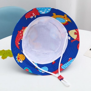 Detail view of cotton kids sun hat with dinosaur prints, size label, and chin strap