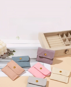 Flat lay of colorful microfiber jewelry snap pouches in soft pastel tones for storage