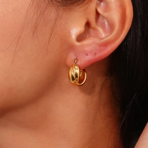 18K gold plated croissant twist hoop earring shown on ear for a minimalist look