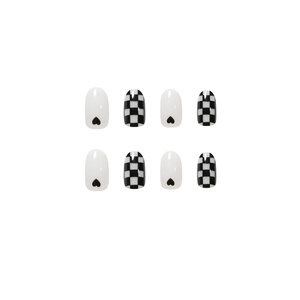 Glossy oval press-on nails featuring black heart accents and classic checkerboard patterns