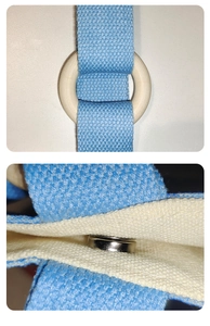 Detail of blue woven handle with wooden ring and secure magnetic snap closure on canvas bag