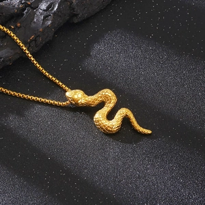 3D snake pendant necklace in golden stainless steel with detailed scale texture