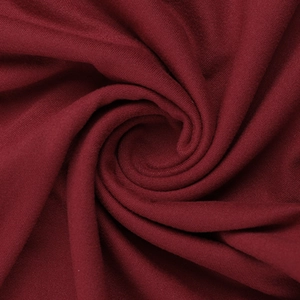 Close-up of deep burgundy lace fabric with fine knitted texture and elegant draping