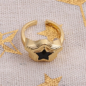 Detailed top view of gold-plated star ring with black zircon inlay and open band