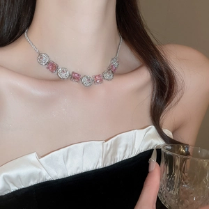 Close-up of elegant flower necklace with pink square zircons and clear crystals on model