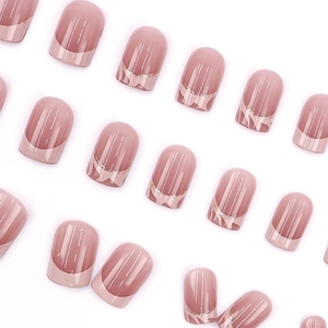 Short oval french press-on nails in dusty rose pink with sparkly gold arc details