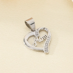 Macro detail of a silver heart pendant with Mom lettering and pavé crystals on a soft fabric