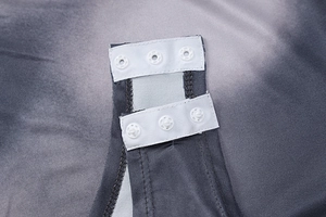 Close-up of bottom snap button closure on grey gradient long sleeve bodysuit