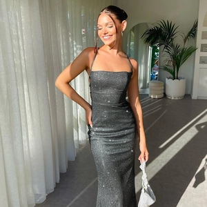 Close-up of shimmering dark grey sequin fabric on backless halter evening dress